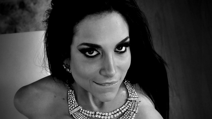 Monochrome portrait of a woman with dramatic makeup and jewelry