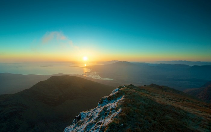 Sunrise over mountains and a lake
