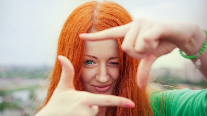 Woman with red hair framing her face