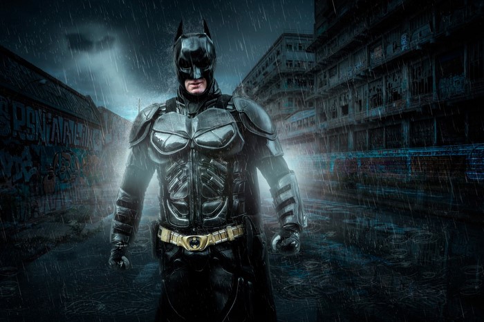 Batman in a dark, rainy city street