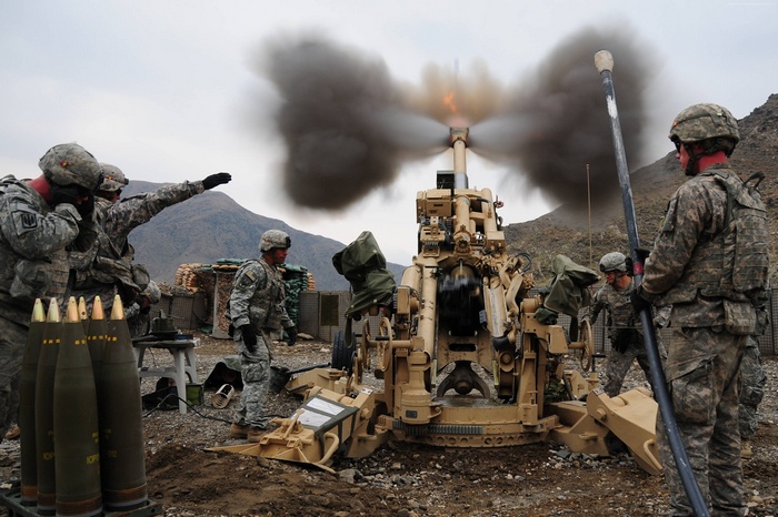 U.S. Army soldiers firing M777A2 howitzer artillery