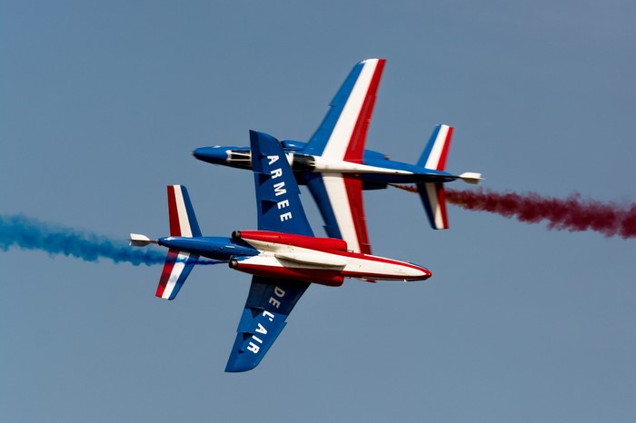 Patrouille de France jets performing aerobatics with smoke trails