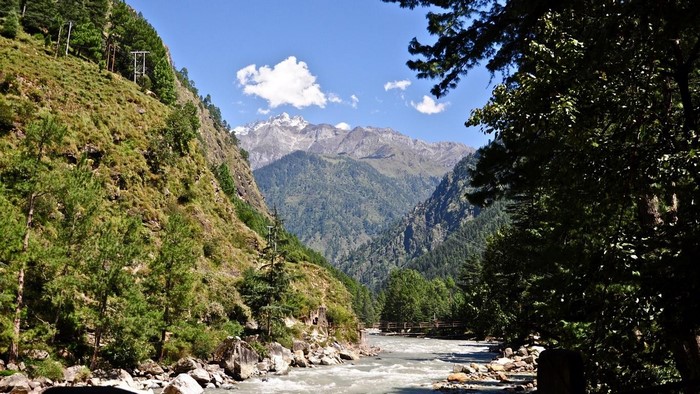 Mountain valley with a river and snow-capped peaks