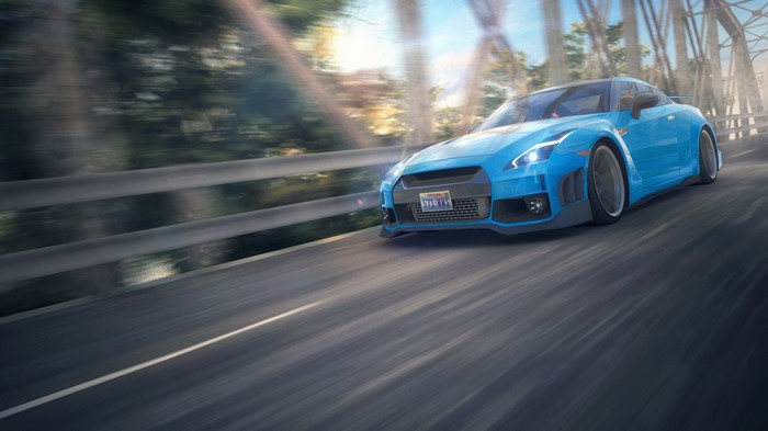 Blue Nissan GT-R driving on a bridge