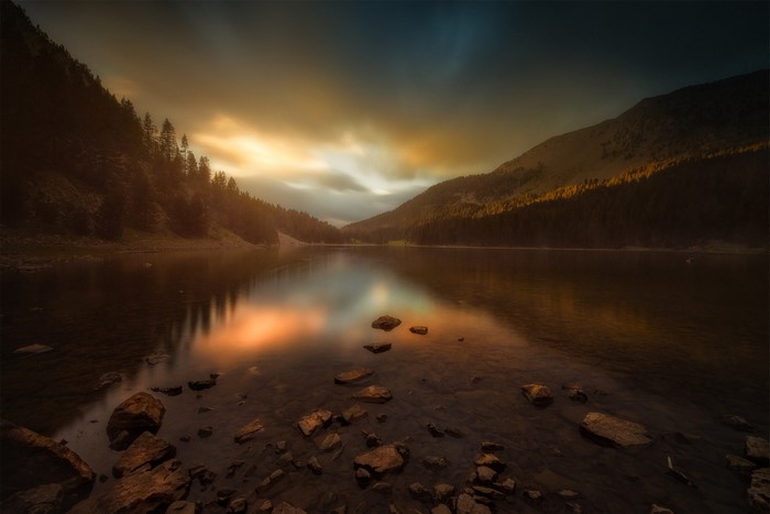 Lake and mountains at sunset with reflection