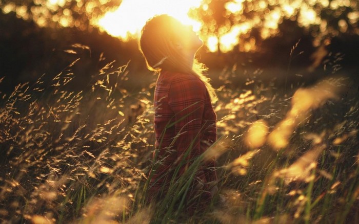 Girl in a field at sunset