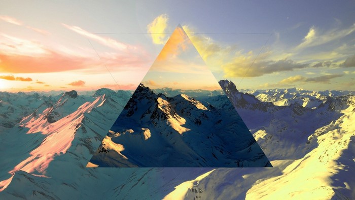 Abstract geometric overlay on snowy mountain range at sunset