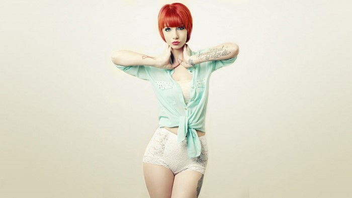 Redhead woman with tattoos in lingerie