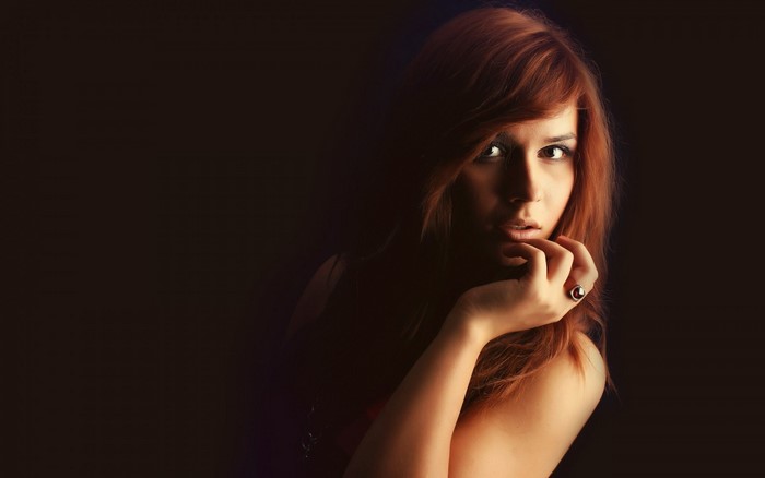 Woman with red hair and ring on hand