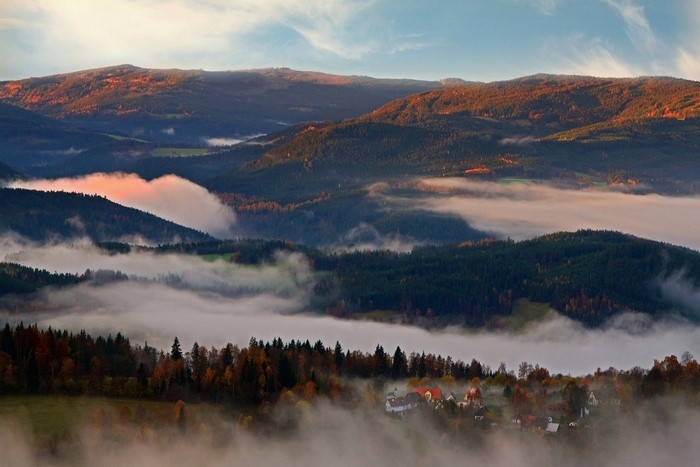 Mountain valley with fog at sunrise