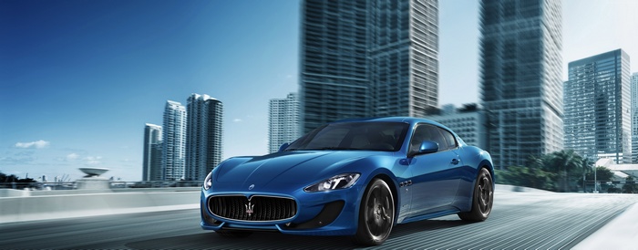 Blue Maserati GranTurismo Coupe driving in city