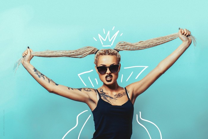 Woman with blonde dreadlocks and sunglasses