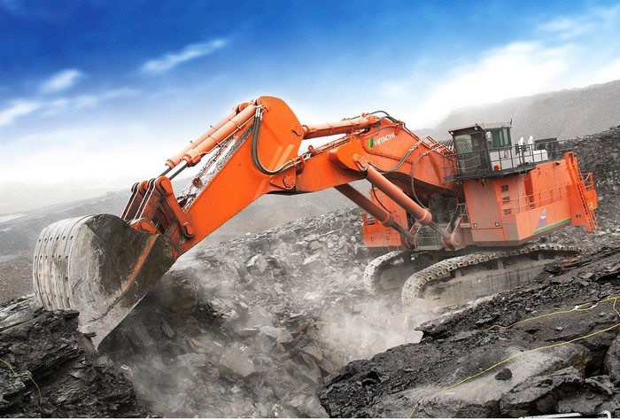 Hitachi excavator digging in a rocky mine