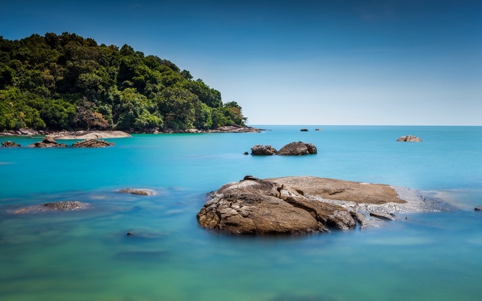 Rocky coastline with turquoise water and clear blue sky
