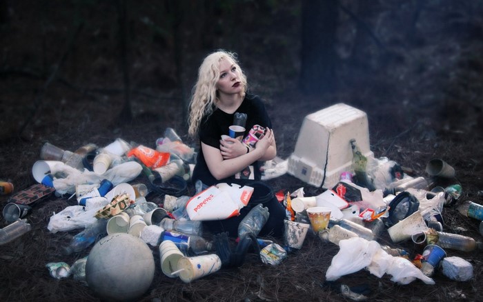Woman sitting in trash