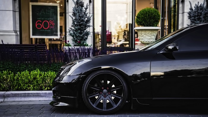 Black Infiniti G35 Coupe parked in front of a store