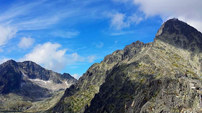 Rocky mountain range with blue sky and clouds