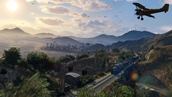 Biplane flying over train tracks in Grand Theft Auto V landscape