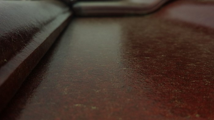 Close-up of a textured red-brown wooden surface