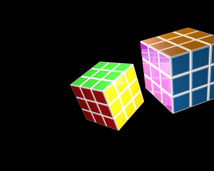 Two Rubik's Cubes on a black background