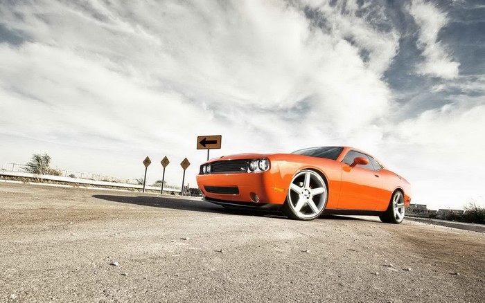 Orange Dodge Challenger SRT on a dirt road