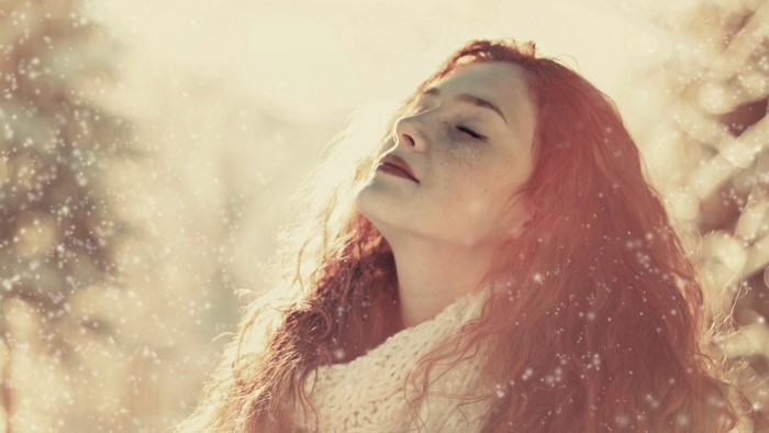 Woman with red hair and freckles in the snow