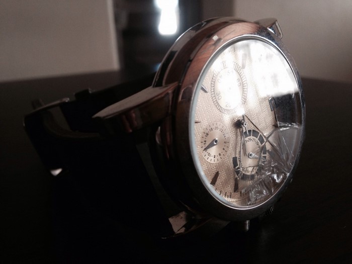 Broken luxury watch with cracked glass