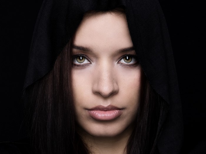 Woman with black hood and dark hair