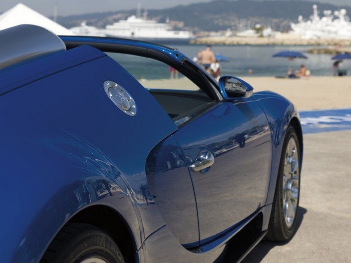 Blue Bugatti Veyron parked by the beach