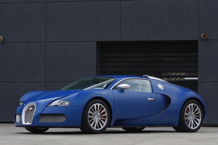 Blue Bugatti Veyron parked in front of a modern building