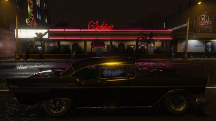 Classic car in front of Singleton's at night