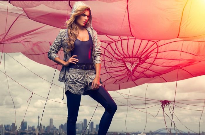 Amber Renae in athletic wear with parachute and city skyline