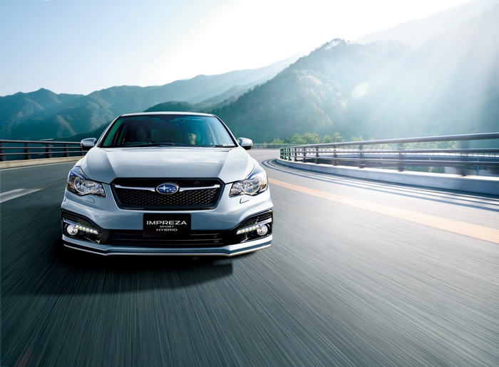 Subaru Impreza Sport Hybrid driving on a mountain road