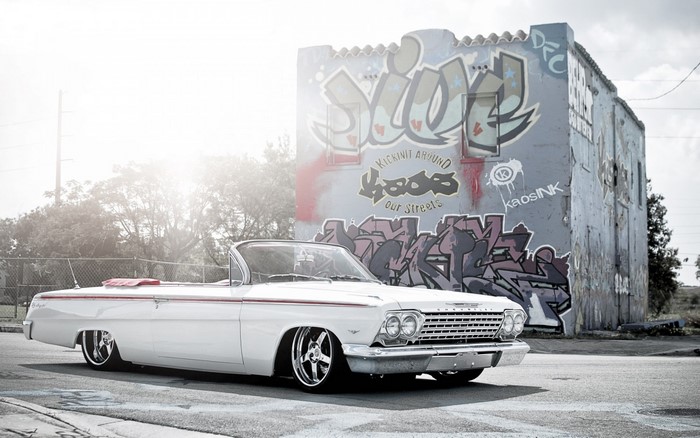 White Chevrolet Impala Lowrider Convertible by Graffiti Building