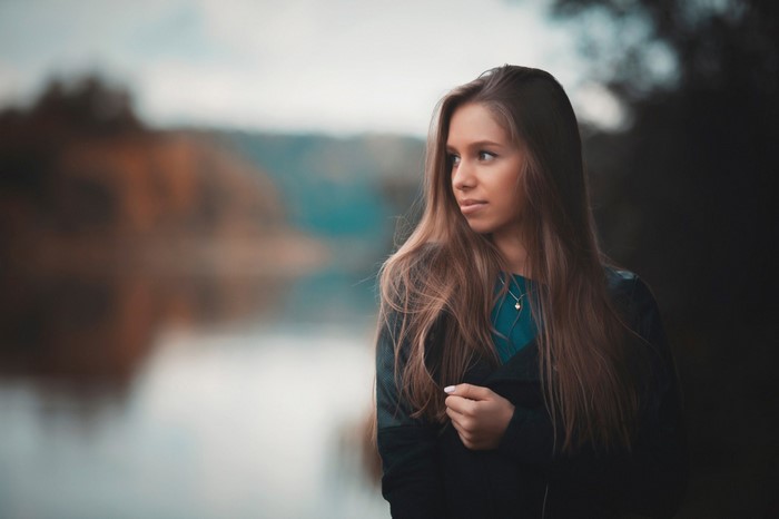 Woman with long brown hair looking to the side
