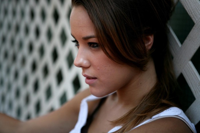 Woman with brown hair in a white top