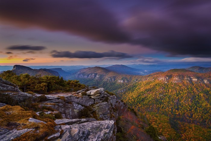 Mountain range at sunset with autumn foliage