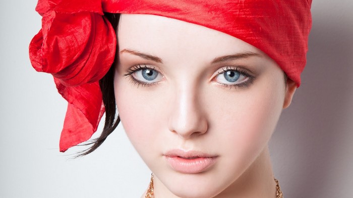 Woman with blue eyes and red headscarf