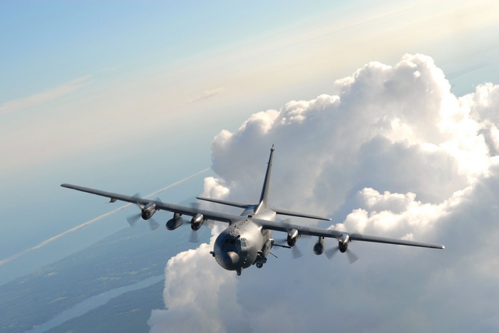 AC-130U Gunship Aircraft Flying Above Clouds