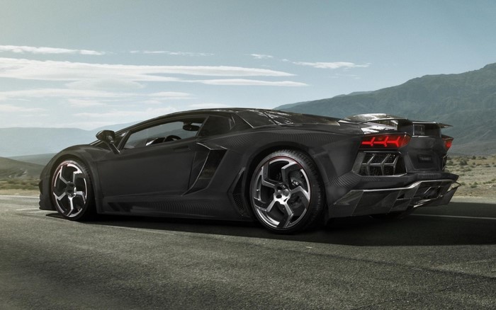 Black Lamborghini Aventador parked on a road