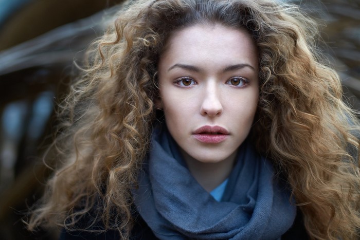 Lisa Alexanina portrait with curly auburn hair and scarf