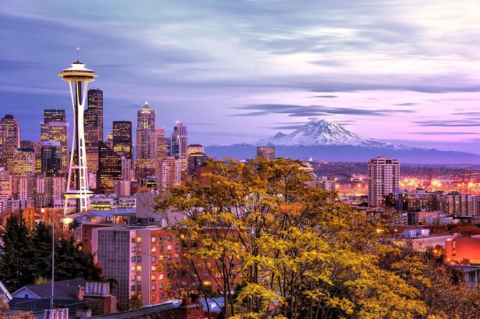 Seattle cityscape with Space Needle and Mount Rainier at sunset