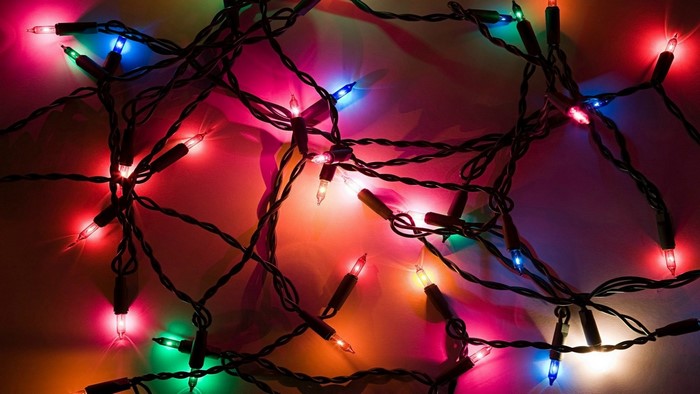Tangled colorful Christmas lights on a dark background