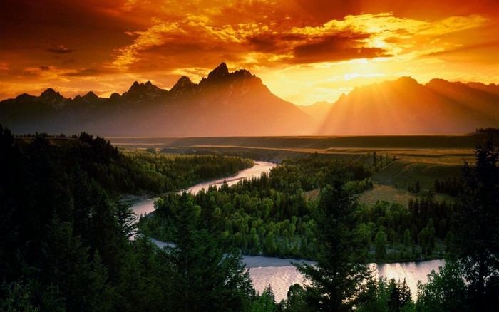 Sunset over mountains and river valley