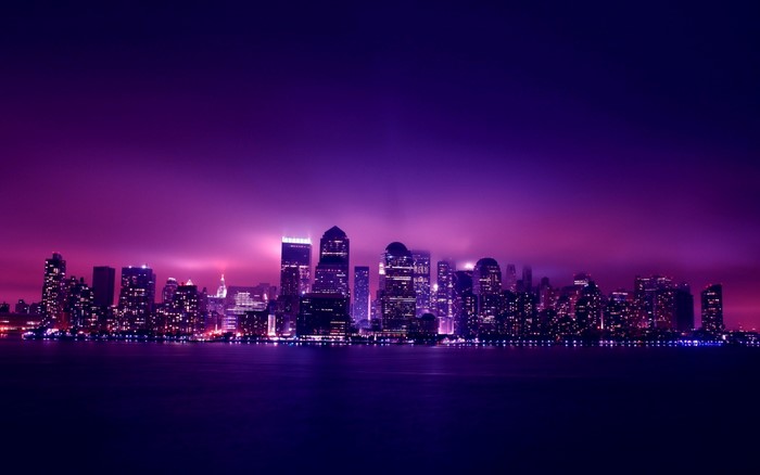 Purple Skyline Cityscape at Night Over Water