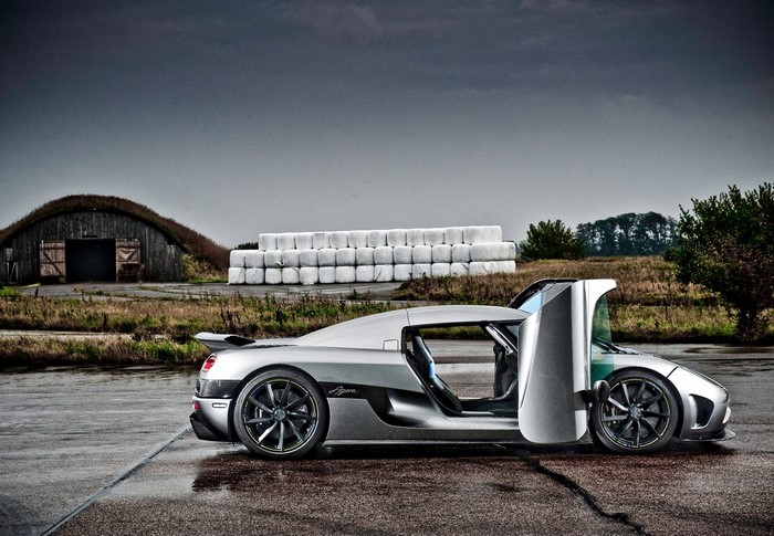 Koenigsegg Agera R with doors open on wet asphalt