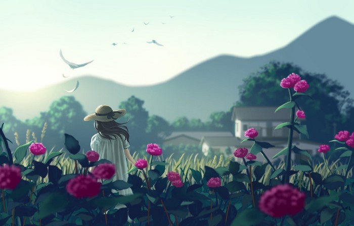 Girl in straw hat in a field of flowers