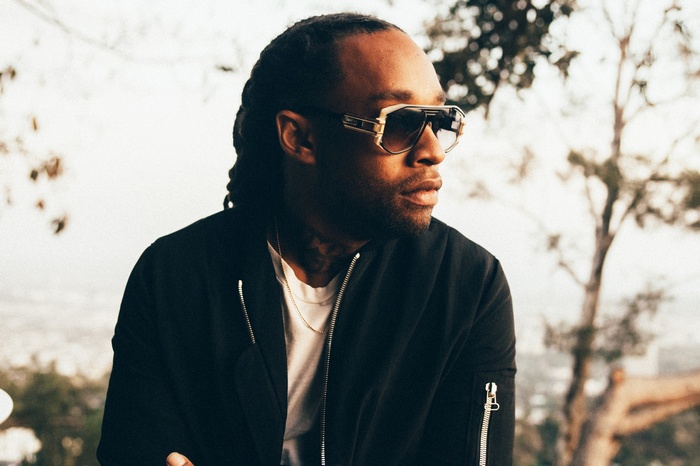 Ty Dolla Sign wearing sunglasses and bomber jacket