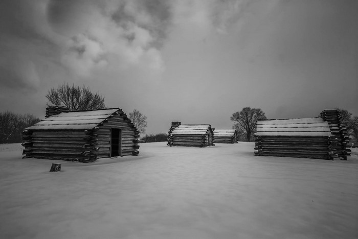 Log cabins in the snow at Valley Forge