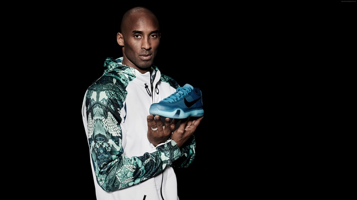 Kobe Bryant holding a Nike basketball shoe